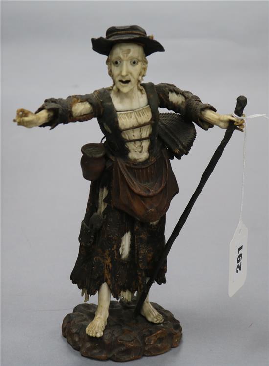 An 18th century German ivory and wood figure of a beggar woman height 24cm